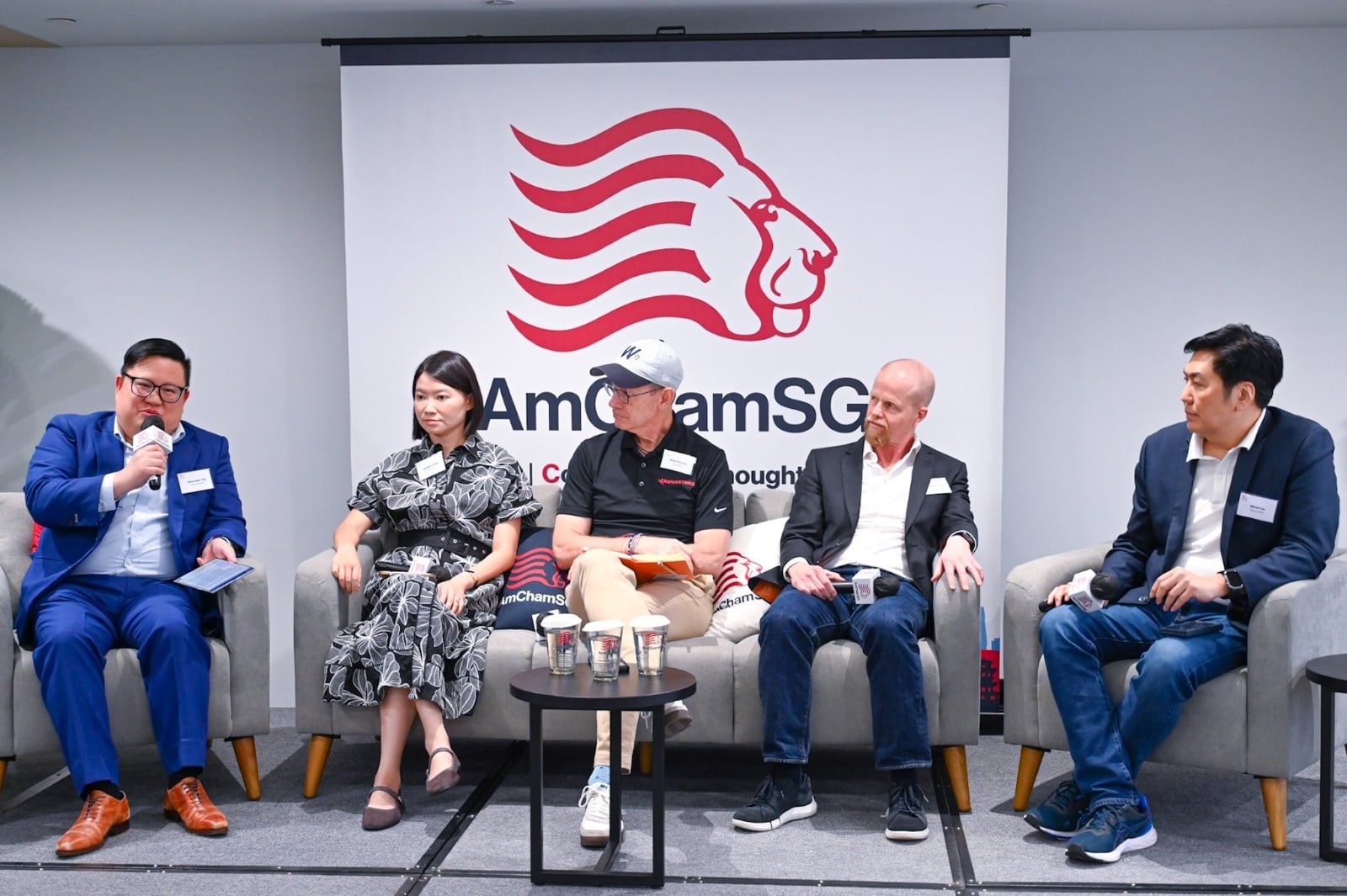 The Mythos & The Curated Frontier panel on stage at the AmChamSG Hub, with Roger Olofsson seated alongside speakers from CrowdStrike, Microsoft, and Cisco